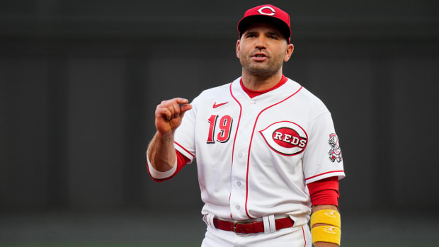 Reds first baseman Joey Votto chats with umpire Ryan Blakney.